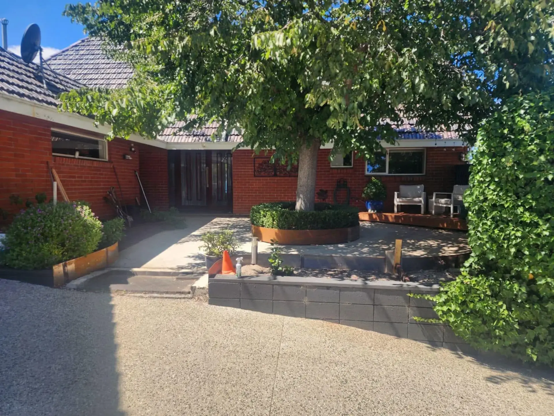A washed exposed aggregate driveway apron in front of a home
