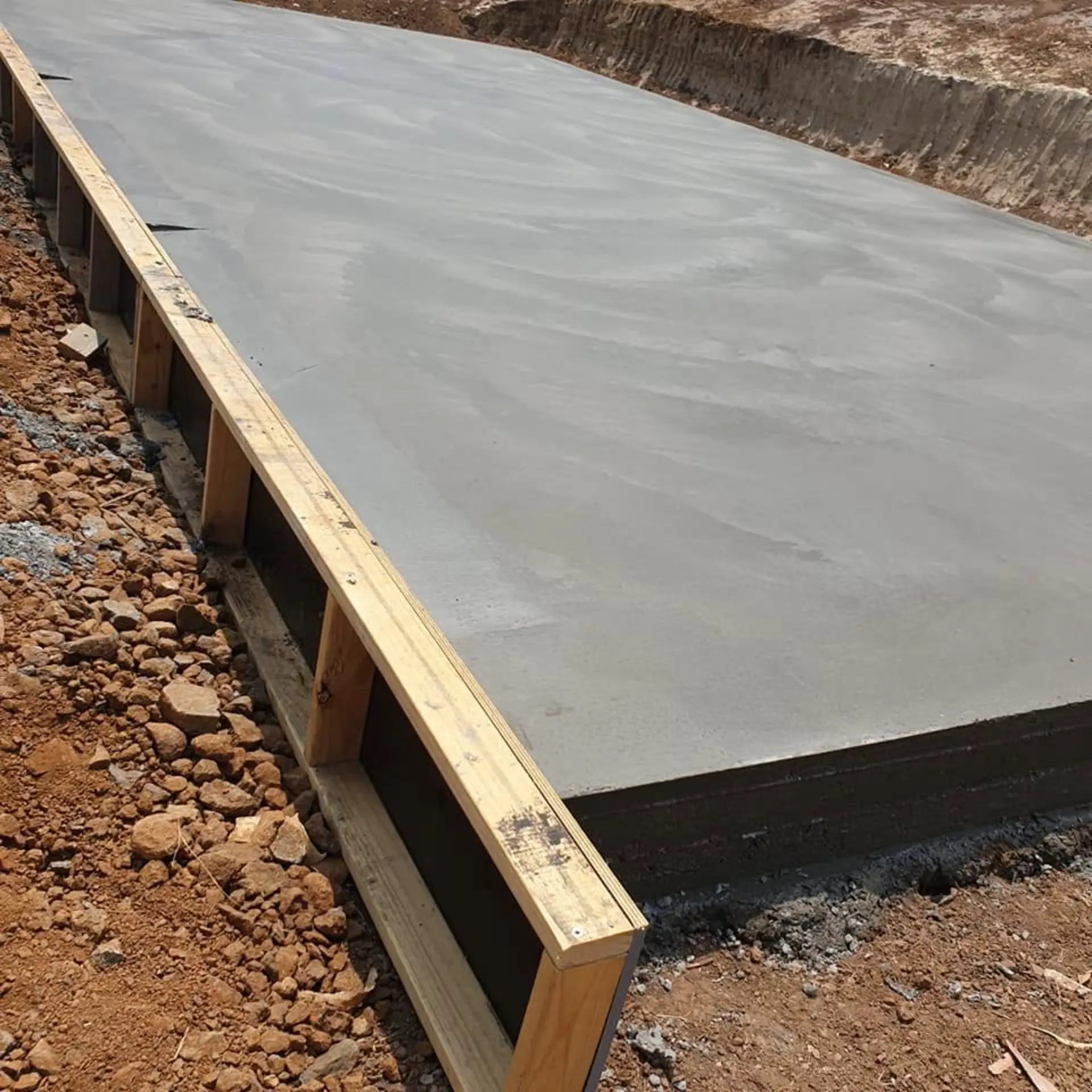 A raised slab supported on timber formwork over stepped ground