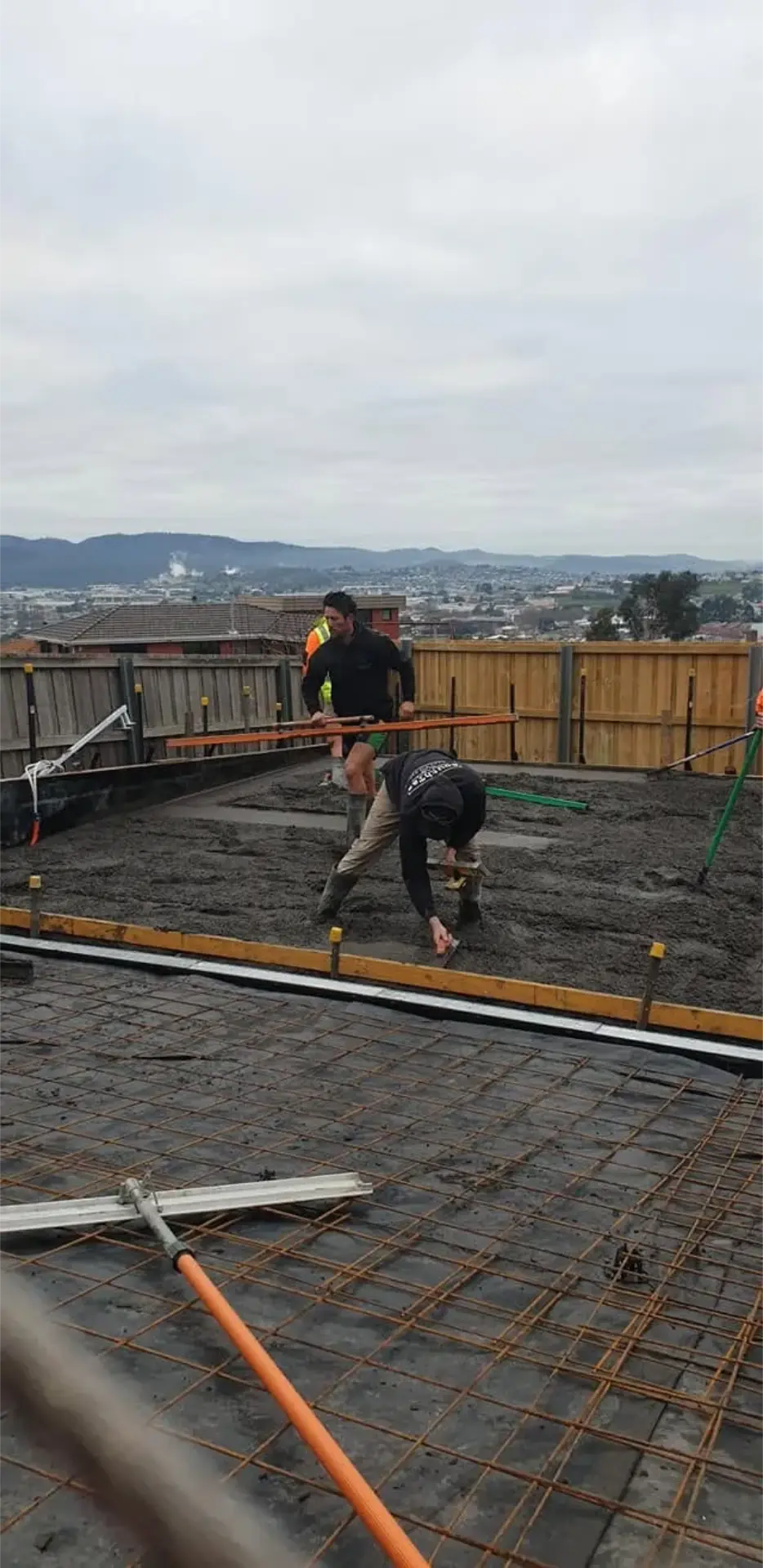 A concreter power-floating a freshly poured residential slab