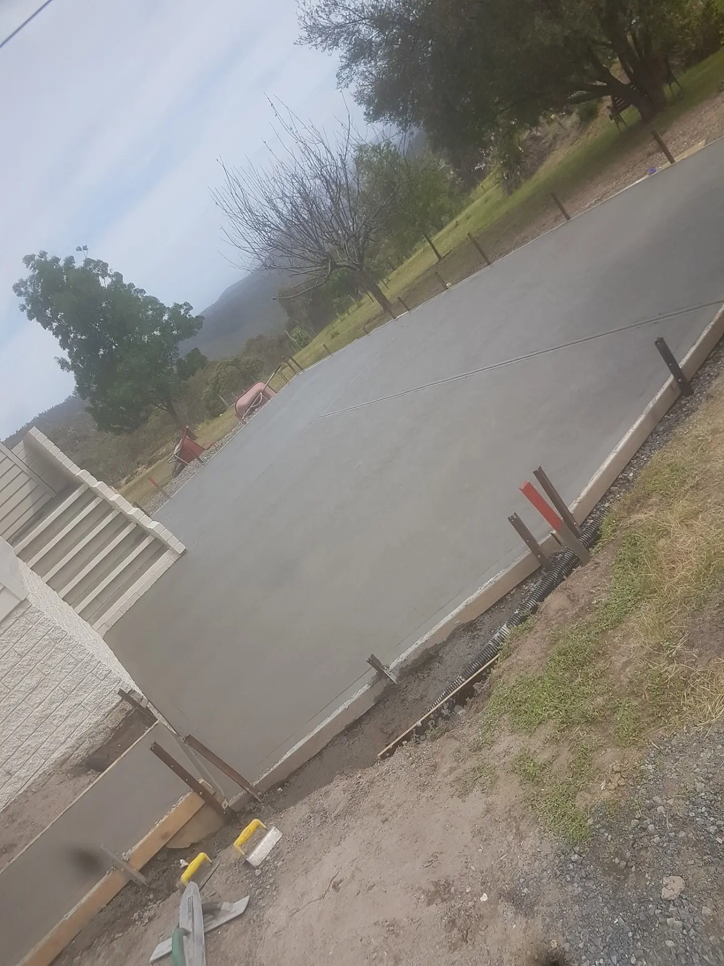 A concrete driveway strip poured out to a quiet rural road