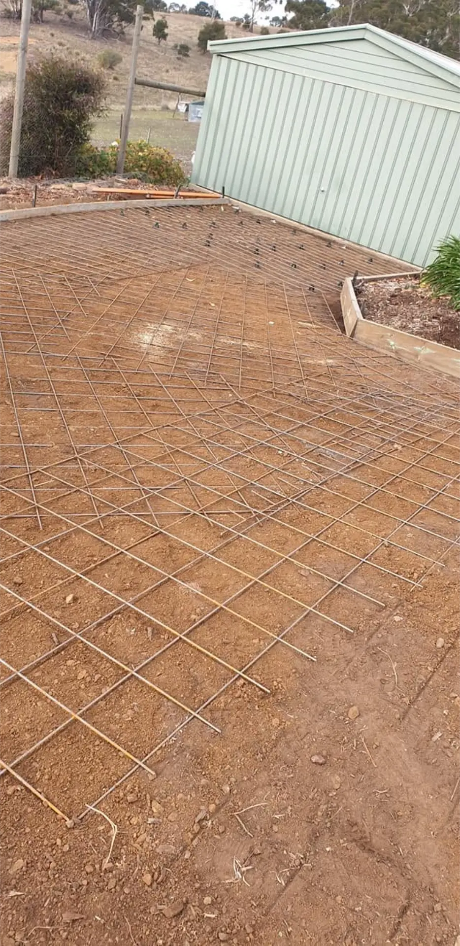 A stamped concrete surface finished in a warm patterned tile look