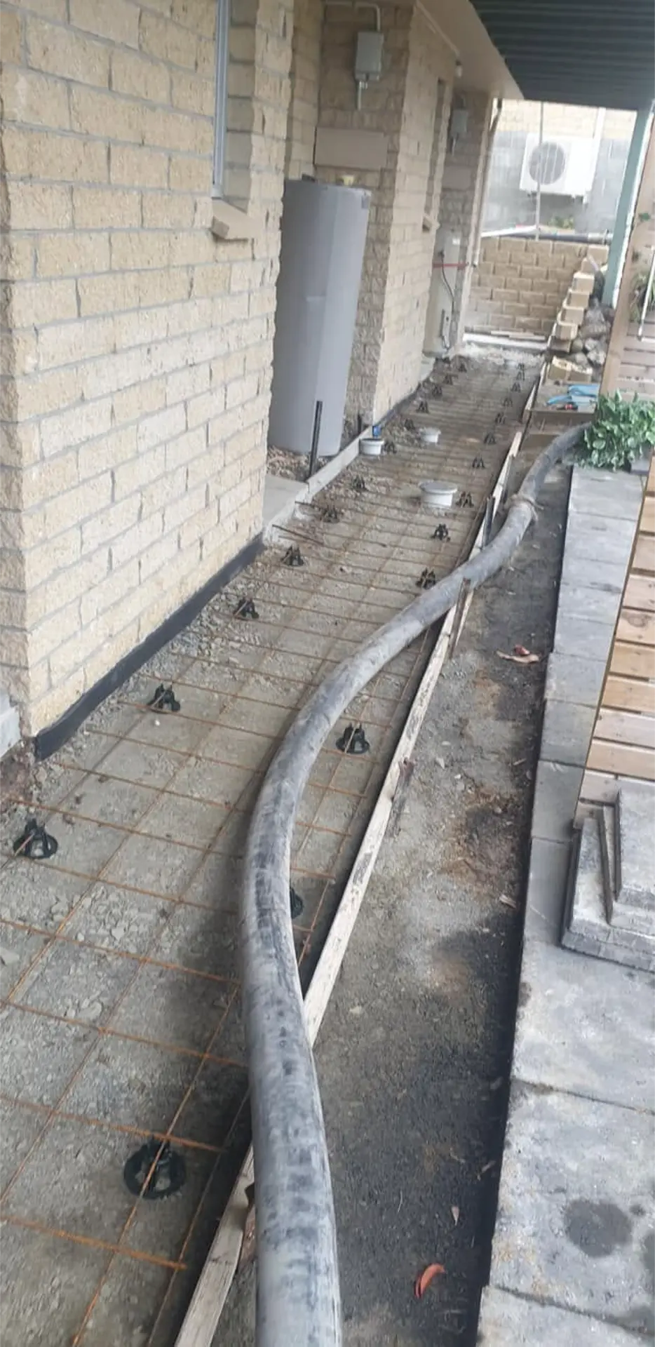 A formed side path with conduit run before the concrete pour