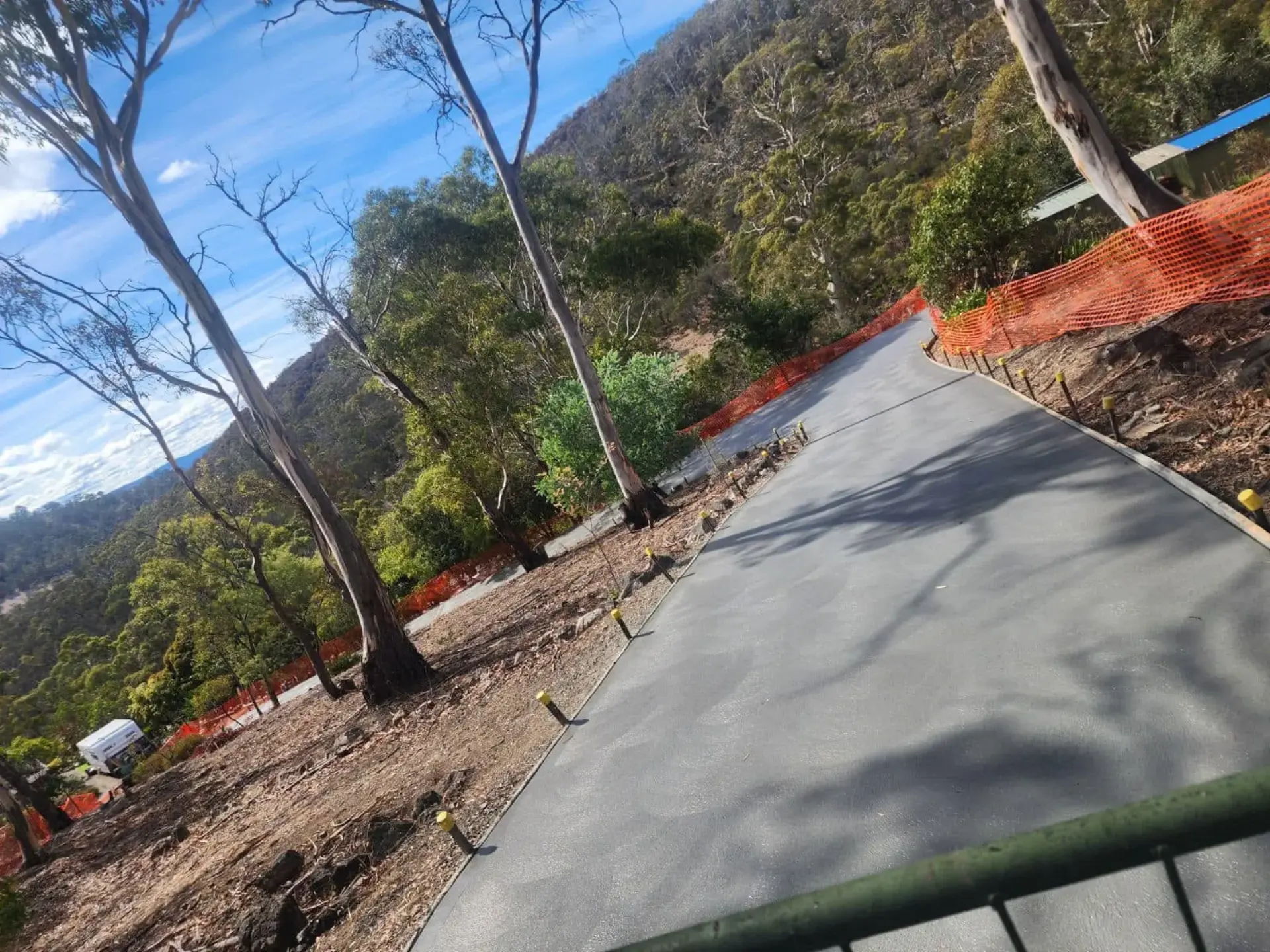 A new driveway poured on a bush block behind safety fencing