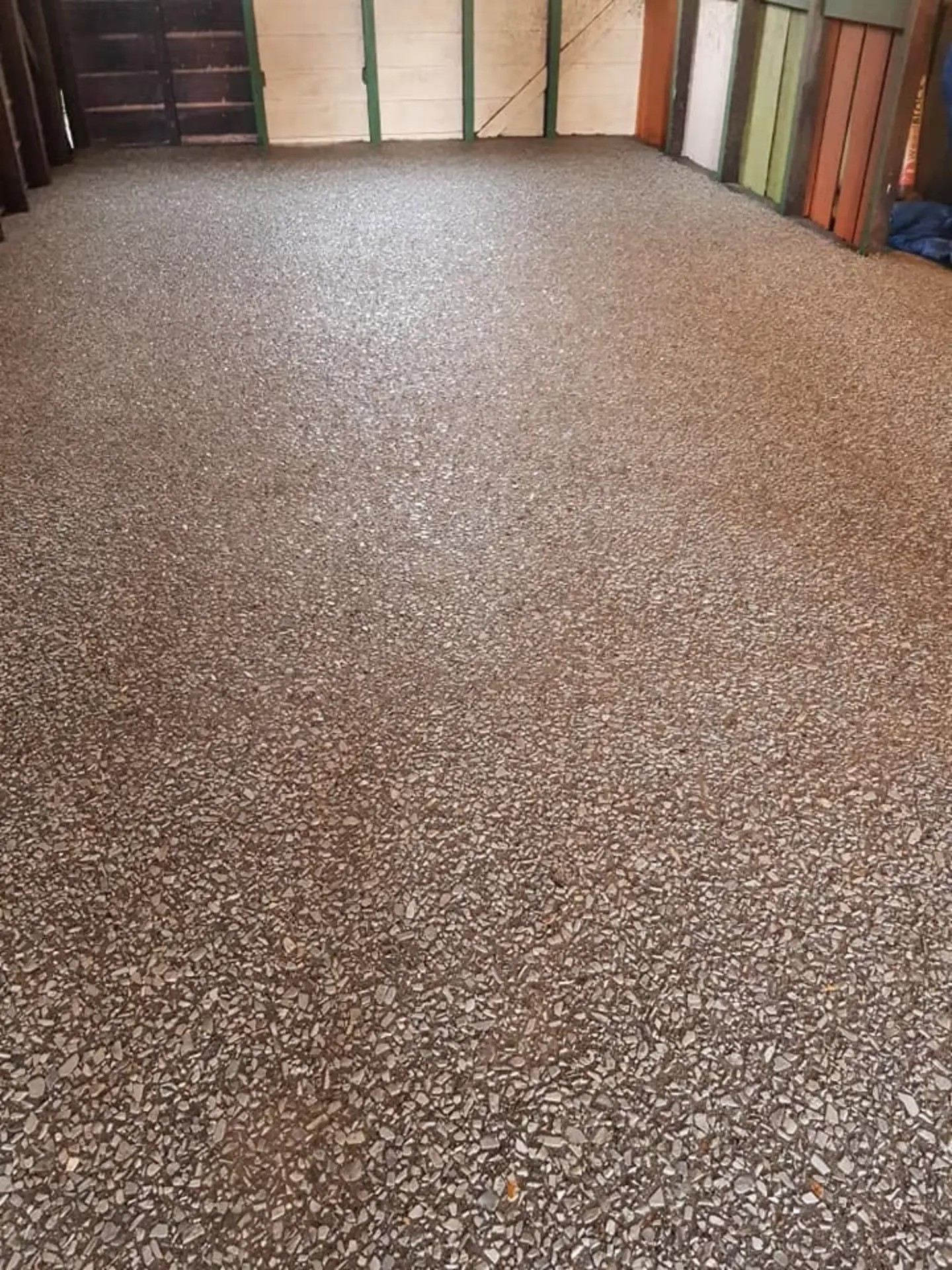 A honey-toned exposed aggregate floor finished under a covered outdoor area
