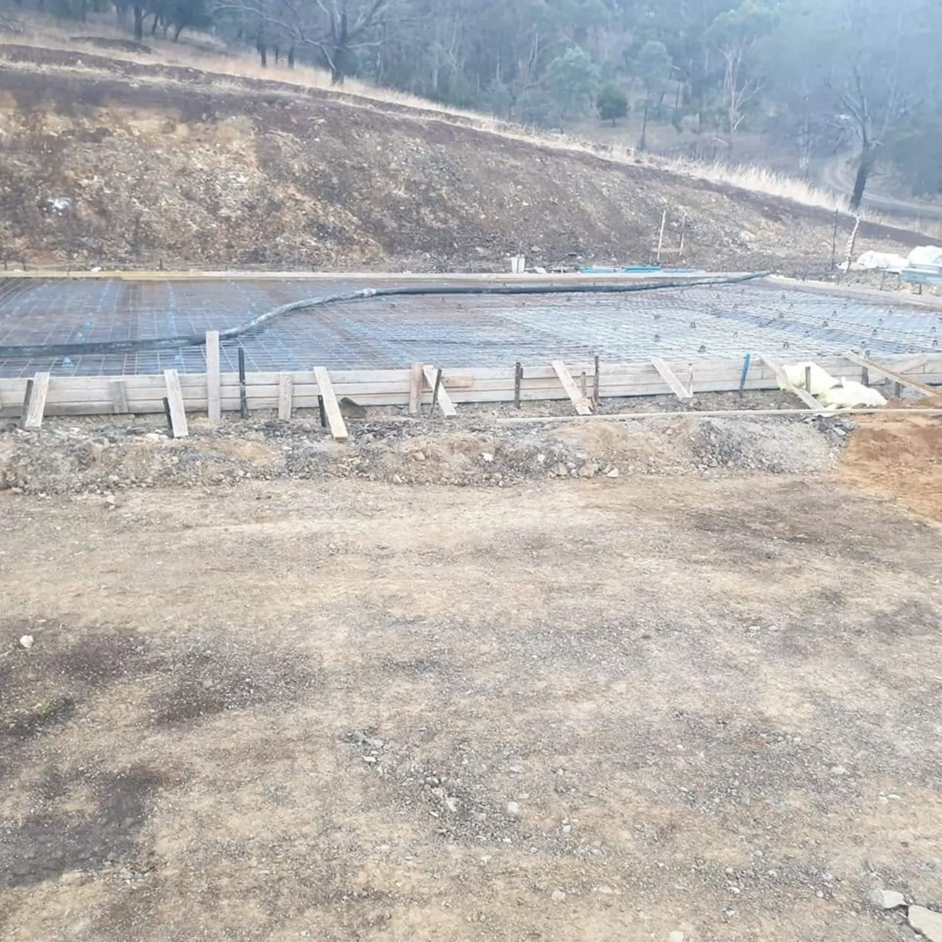 A set-out footing area pegged and formed on a cleared site